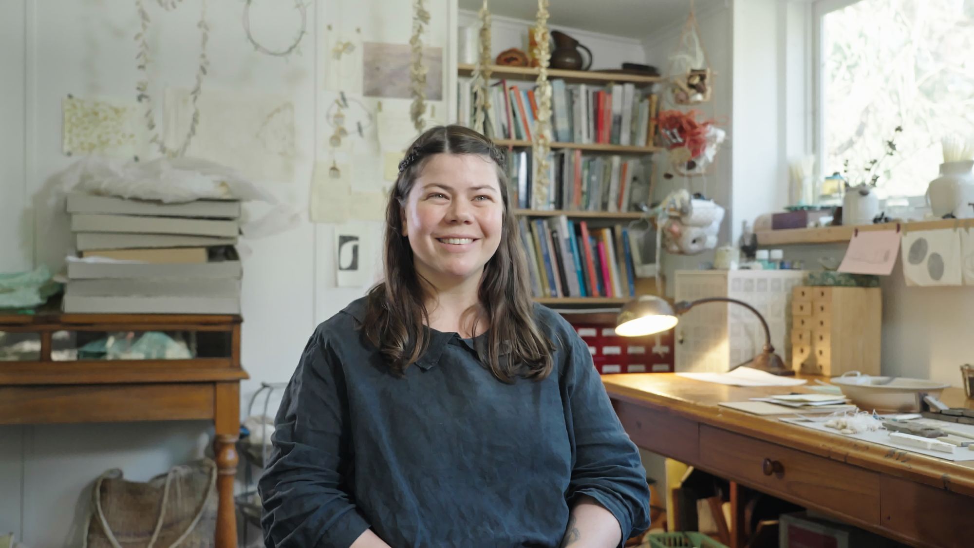 A smiling woman in her studio