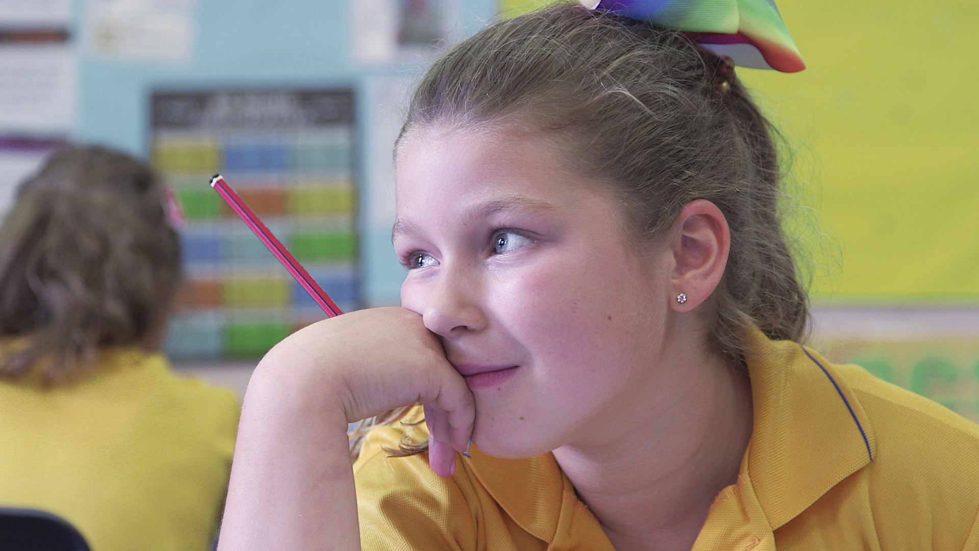 A schoolgirl smiling in a classroom